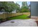 Landscaped backyard featuring a stone patio and a well-maintained lawn with a wooden fence at 1000 Marilyn Dr, Raleigh, NC 27607