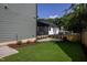 Large backyard featuring a stone patio, lush lawn, professional landscaping, and a screened-in porch at 1000 Marilyn Dr, Raleigh, NC 27607