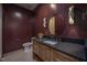 Bathroom with dark walls, wooden vanity, and gold accents at 1000 Marilyn Dr, Raleigh, NC 27607
