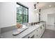 A luxurious bathroom features quartz countertops, modern fixtures, and sinks at 1000 Marilyn Dr, Raleigh, NC 27607