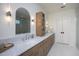 Bathroom featuring dual sinks, wood cabinetry, and a marble countertop at 1000 Marilyn Dr, Raleigh, NC 27607