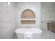 Soaking tub with tile surround and an alcove feature in a luxurious bathroom at 1000 Marilyn Dr, Raleigh, NC 27607
