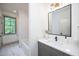 Stylish bathroom featuring modern fixtures, a soaking tub, and a large window offering natural light at 1000 Marilyn Dr, Raleigh, NC 27607