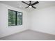 Bright bedroom featuring a modern ceiling fan and a large window with black trim at 1000 Marilyn Dr, Raleigh, NC 27607