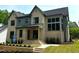 New construction home boasts a brick and siding exterior with a covered porch and manicured lawn at 1000 Marilyn Dr, Raleigh, NC 27607
