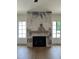 Living room features a fireplace with decorative marble tiling, wood mantel, and hardwood flooring at 1000 Marilyn Dr, Raleigh, NC 27607