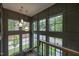 Dramatic two-story foyer with three pendant lights and large windows at 1000 Marilyn Dr, Raleigh, NC 27607