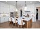 Gourmet kitchen with white cabinetry, stainless steel appliances, and a spacious center island with seating at 1000 Marilyn Dr, Raleigh, NC 27607