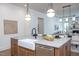 Kitchen island features a farmhouse sink, stainless steel dishwasher, and seating at 1000 Marilyn Dr, Raleigh, NC 27607