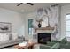 Cozy living room featuring a stylish marble fireplace and a modern wooden mantel at 1000 Marilyn Dr, Raleigh, NC 27607