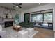 Bright living room with a marble fireplace, hardwood floors, and sliding glass doors to the outdoor space at 1000 Marilyn Dr, Raleigh, NC 27607