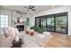Bright living room with a marble fireplace, hardwood floors, and sliding glass doors to the outdoor space at 1000 Marilyn Dr, Raleigh, NC 27607