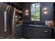 Stylish pantry with stainless steel refrigerator, dark cabinetry, and open shelving at 1000 Marilyn Dr, Raleigh, NC 27607