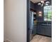 Butler's pantry with stainless fridge, dark cabinets, and outside view at 1000 Marilyn Dr, Raleigh, NC 27607