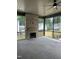 Spacious screened-in porch featuring stone flooring and a brick fireplace at 1000 Marilyn Dr, Raleigh, NC 27607