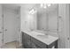 Double vanity bathroom with gray cabinets and quartz countertops at 9228 Kitchin Farms Way # 412, Wake Forest, NC 27587