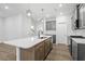 Spacious kitchen island with quartz countertops and gray cabinets at 9228 Kitchin Farms Way # 412, Wake Forest, NC 27587