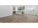 Modern kitchen with gray cabinets, island, and hardwood floors at 9228 Kitchin Farms Way # 412, Wake Forest, NC 27587