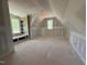 Unfinished attic bedroom boasts unique angles, window nooks, and a built-in bookcase at 155 Gaines Trl, Pittsboro, NC 27312