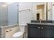 Modern bathroom with blue tile shower, glass partition, and granite countertop vanity with gold fixtures at 155 Gaines Trl, Pittsboro, NC 27312