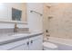 Modern bathroom with white vanity, grey countertop, shower-tub combo, and marbled tile at 155 Gaines Trl, Pittsboro, NC 27312