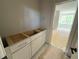 Bathroom vanity with an open door showing a view into a light-filled room at 155 Gaines Trl, Pittsboro, NC 27312