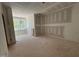 Well-lit room featuring three windows with exterior view and unfinished walls at 155 Gaines Trl, Pittsboro, NC 27312