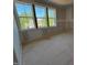 Bright bedroom features three windows with exterior view of a neighboring home at 155 Gaines Trl, Pittsboro, NC 27312