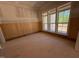 Spacious bedroom featuring wood paneled walls and large windows letting in plenty of natural light at 155 Gaines Trl, Pittsboro, NC 27312