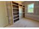 Bright bedroom featuring a built-in bookcase and desk area by a sunlit window at 155 Gaines Trl, Pittsboro, NC 27312