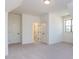 Large bedroom with neutral carpet, many windows, and three doors to other parts of the home at 155 Gaines Trl, Pittsboro, NC 27312