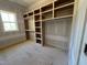 Unfinished closet featuring wooden shelving and racks at 155 Gaines Trl, Pittsboro, NC 27312