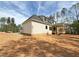 Side view of a charming two-story home with a covered porch and ample yard space at 155 Gaines Trl, Pittsboro, NC 27312