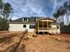 Back view of a charming two-story home with a covered porch and ample yard space at 155 Gaines Trl, Pittsboro, NC 27312