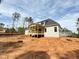 Back view of a charming two-story home with a covered porch and ample yard space at 155 Gaines Trl, Pittsboro, NC 27312