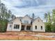 Charming new construction home with white siding, black trim, and a welcoming front porch at 155 Gaines Trl, Pittsboro, NC 27312
