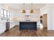This bright, eat-in kitchen features stainless appliances, a dark island, and double ovens at 155 Gaines Trl, Pittsboro, NC 27312