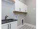 Charming laundry room with a granite sink and countertop, with patterned tile floor at 155 Gaines Trl, Pittsboro, NC 27312