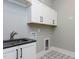 Laundry room with white cabinets, a sink, and patterned floor tile at 155 Gaines Trl, Pittsboro, NC 27312