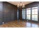 Elegant living room with dark walls, hardwood floors, and a modern chandelier at 155 Gaines Trl, Pittsboro, NC 27312