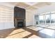 Inviting living room with coffered ceilings, marble fireplace, built-in shelving, and sliding glass door at 155 Gaines Trl, Pittsboro, NC 27312