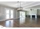 Open living space featuring modern lighting, fireplace, built-in shelving, and sliding glass doors at 155 Gaines Trl, Pittsboro, NC 27312