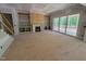 Open living room featuring built-in shelving, a fireplace, and large windows at 155 Gaines Trl, Pittsboro, NC 27312