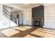 Bright living room with hardwood floors, adjacent to staircase, fireplace and built-in shelving at 155 Gaines Trl, Pittsboro, NC 27312