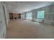Open living room featuring built-in shelving, a fireplace, and large windows at 155 Gaines Trl, Pittsboro, NC 27312