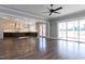 Open living space features hardwood floors connecting the living room and kitchen with outdoor access at 155 Gaines Trl, Pittsboro, NC 27312