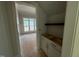 Walk-in pantry with white cabinets and view of a window and well-lit room at 155 Gaines Trl, Pittsboro, NC 27312