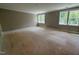 Spacious room with natural light streaming through large windows, creating a warm and inviting atmosphere at 155 Gaines Trl, Pittsboro, NC 27312