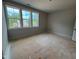 Well-lit room with a set of windows offering a scenic view, creating a cozy and inviting space at 155 Gaines Trl, Pittsboro, NC 27312