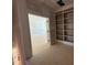 Unfinished room showcasing open doorway to a brightly lit room with built in bookcase at 155 Gaines Trl, Pittsboro, NC 27312